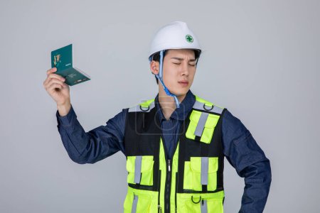 millennials and gen z, korean asian young man, site staff holding a bankbook and pondering, studio background