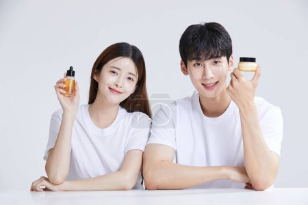 korean asian young couple with cosmetics, studio background