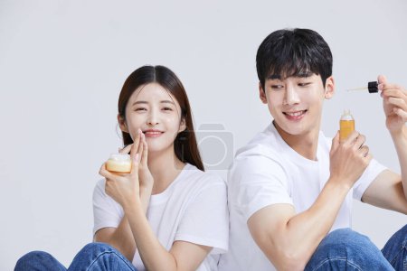 korean asian young couple with cosmetics, studio background
