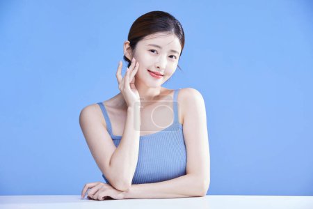 beauty concept photo of korean asain beautiful woman touching her skin, studio background