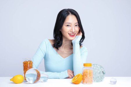 A woman sitting in front of pill lemon tangerine orange