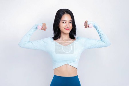 A woman holding a dumbbell