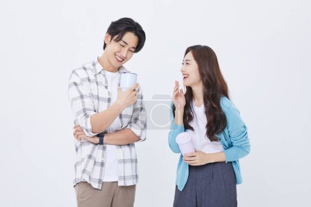 A man and a woman holding a cup of water while preparing for a youth start up