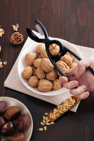 Various nuts are peeling walnuts on the table on the plate