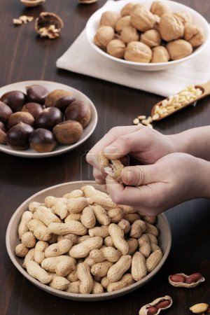 peel peanuts with both hands