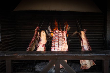 Photo for Ribs grilled on the fire in a "asador criollo". Traditional food. - Royalty Free Image