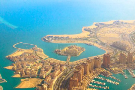 Photo for Aerial view of the Pearl-Qatar, the luxurious and modern artificial island in Persian Gulf, Doha, Qatar, Middle East. Details of Venice at Qanat Quartier and Marsa Malaz Kempinski hotel. Scenic flight - Royalty Free Image