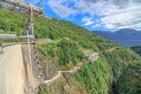 Photo for Verzasca, Switzerland - June 2021: Highest Bungee jumping of Europe. Verzasca dam on Vogorno lake of Switzerland. Bungee jumping location and set of James Bond movies in Ticino. - Royalty Free Image