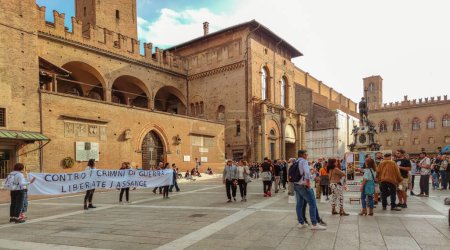 Photo for Bologna, Italy - October 15, 2022: street protest for Julian Assange founder of WikiLeaks, extradition from UK to United States. In Piazza Maggiore downtown square. With Neptune 1500s bronze fountain. - Royalty Free Image