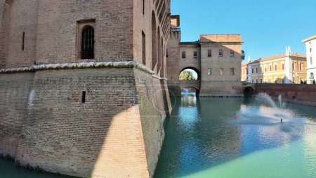 Photo for Ferrara Castle, known as Castello Estense, is a medieval fortress in the center of Ferrara, Italy, constructed in 1385. Encircled by moat, the castle comprises a sizable central block with four towers - Royalty Free Image