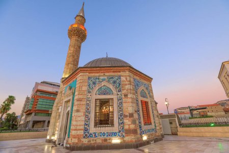 Photo for Konak Mosque with octagonal shape and intricate tilework, serene oasis in Izmirs Konak Square. Built in 1755 its jewel of history.Stands as historic symbol next to Governors Mansion and Clock Tower - Royalty Free Image