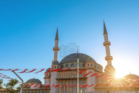 journey around Taksim Mosque in Istanbul with Turkish flags captures its modern beauty at sunset.