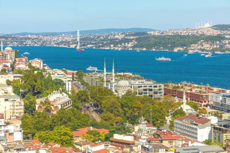 Galata Tower aerial view on Istanbul skyline featuring the bosphorus strait on a clear sunny day in Turkey.