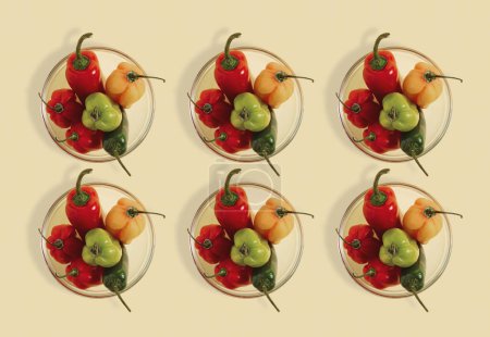 Foto de Peppers in a glass pots on the table. Seamless pattern, flat lay composition on yellow background, spicy healthy eating concept - Imagen libre de derechos