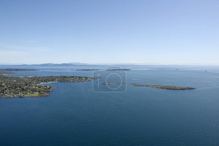 Aerial photo of the community of Oak Bay with the Trial Islands Ecological Reserve to the right and Mt. Baker in Washington State in the background, Victoria, Vancouver Island, British Columbia