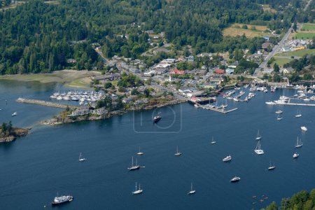 Aerial photograph of boats at anchor in front of the town of Ganges, Salt Spring Island, British Columbia, Canada