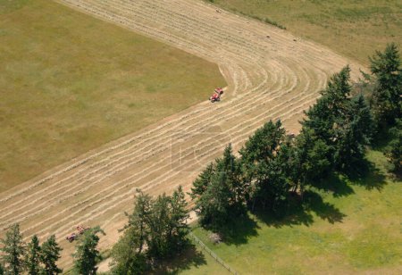 Ploughing a hay field from the air, Salt Spring Island, British Columbia, Canada