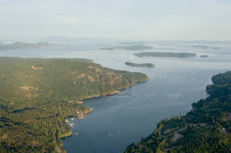 High aerial photo looking over Fulford Harbour with the town and BC Ferry terminal at the left. Russell Island and Portland Island are at the head of the harbour, Saltspring Island, British Columbia, Canada