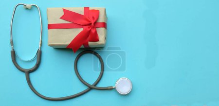 Photo for Medical stethoscope with gift box isolated on a blue pastel background. concept christmas and new year.horizontal photo - Royalty Free Image