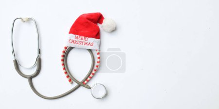 Photo for Medical stethoscope with  decorated Beautiful headband  Decorative red Santa Hat. Background for congratulations to doctors.  life christmas and new year holidays. - Royalty Free Image