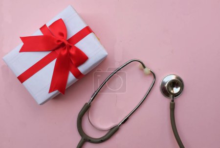 Photo for Medical stethoscope with gift box isolated on a pink pastel background. concept christmas and new year.horizontal photo - Royalty Free Image