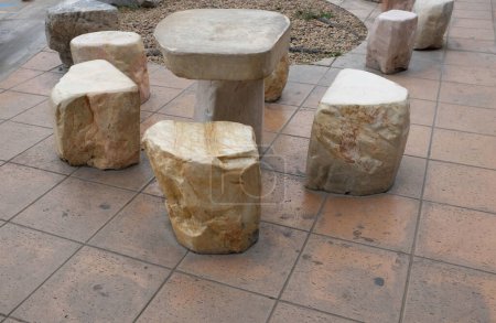 benches in the shape of mushrooms made of solid carved stone. connection of block and stone slabs, for paving near the house. chairs firmly situated in groups.Stone seat in one of Thailand's 