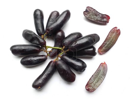 Bunch of fresh Sweet black seedless Moon Drops grape,Purple Witch Finger grapes,Sapphire Grapes or Witch Fingers grape isolated on white backdrop.black grapes. Grapes black taste sweet growing nature
