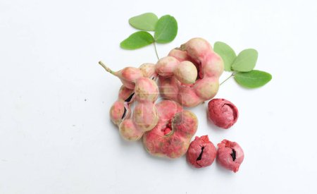 fresh red ripe a Manila tamarind fruit (Pithecellobium dulce) pods with seed isolated on white backdrop.Popular fruit in thailand.Healthy tropical exotic fruits