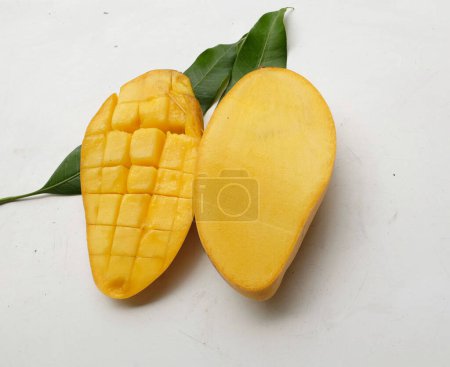 ripe yellow mango golden ,mango nam dok mai mango ,barracuda mango ( mangifera indica) king of fruit cut in half sliced with leaves isolated on a  white backdrop.tropical exotic fruit and healthyfruit