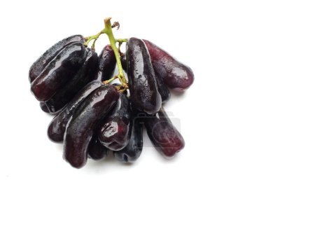 Bunch of fresh Sweet black seedless Moon Drops grape,Purple Witch Finger grapes,Sapphire Grapes or Witch Fingers grape isolated on a white backdrop.black grapes