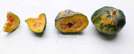 A pile of fresh raw green Japanese pumpkin (Cucurbita moschata) ,Kabocha squash,isolated on a white backdrop.Healthy food vegetable, fruit, and food business idea