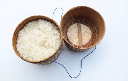 Wooden bamboo traditional style box with Warm steamed Thai sticky rice on white background put in a casserole. bamboo container for holding cooked glutinous rice. A popular staple food in thailand