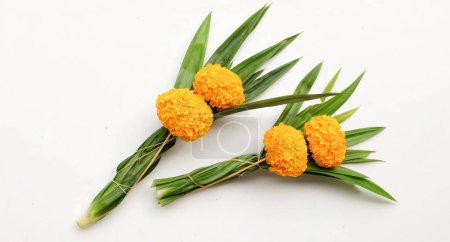  a bunch of marigold. yellow flowers and green leaves panda isolate on a white backdrop . flowers for worship lord buddha at the temple