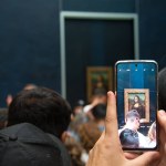 Paris, France; 8th August 2023: a person photographing Mona Lisa at The Louvre Museum