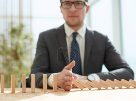 Photo for Businessman with dominoes in the office - Royalty Free Image