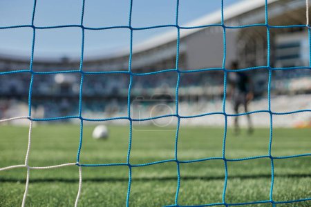 Photo for Football goal post with net, back view. Association football goal on the field - Royalty Free Image