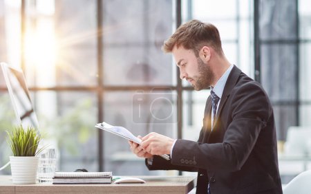 Photo for Businessman Taking Papers From Secretary In Office - Royalty Free Image