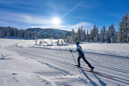 Photo for Nice and active senior woman cross-country skiing in the Hochhaedrich area of Bregenz Forest in Vorarlberg, Austria - Royalty Free Image