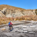nice, active senior woman with her electric mountain bike on a trail tour in the desert of Tabernas near Almeria, Andlusia, Spain