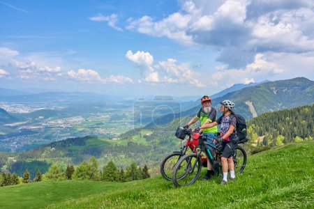 Foto de Pareja de ancianos activos en un recorrido en bicicleta de montaña en los alpes carintios por encima de Villach en Austria - Imagen libre de derechos