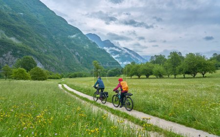 active senior couple  on a e-bike tour in the Valley of River Soca, Triglav National Park near Kobarid, Slovenia