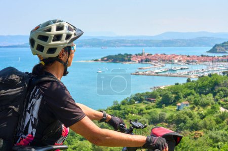 Photo for Nice active senior woman on a mountain bike tour at the Slovenian Mediterranen cost above Izola - Royalty Free Image