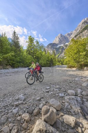 Photo for Active senior couple  on a e-bike tour in the Valley of River Soca, Triglav National Park near Kobarid, Slovenia - Royalty Free Image