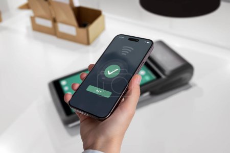 Mobile phone completes a payment on a POS terminal, showcasing a seamless and modern transaction experience at a point of sale