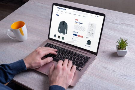 Shopping for men's blazers online, exploring various colors, using a laptop on an e-commerce platform for a seamless experience