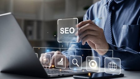 Hand of businessman holding a pen pointing to SEO Search Engine Optimization on laptop screen. Digital marketing process, Strategy,  Business Technology concept.