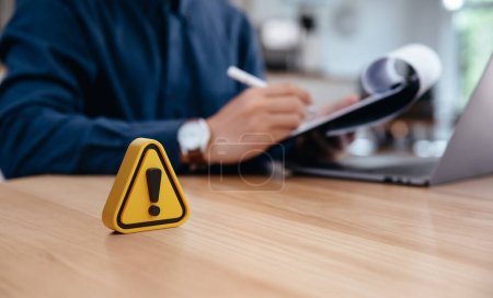 Photo for Warning sign on table in front of businessman Caution in investing Economic situation warning, Deflation and  inflation concept money saving for retired and office syndrome also. - Royalty Free Image