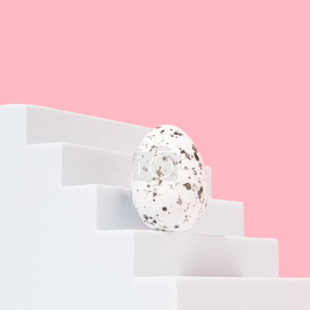 Modern composition made of Easter egg on white stairs. Pastel pink background. Background for branding and packaging presentation. Product concept.
