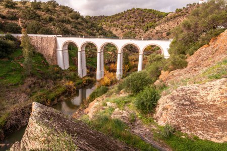 Photo for Old arch bridge over the  Guadiana river  in Mertola - Royalty Free Image