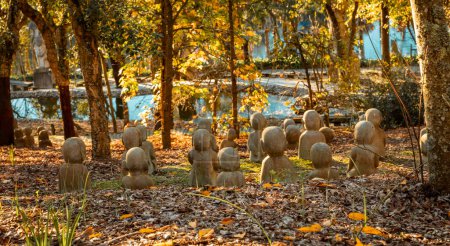 Landscape in Oriental Garden Bacalhoa Buddha Eden Park with Monk stone figures in Portugal